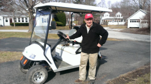 Laddie is proud of his golf cart.